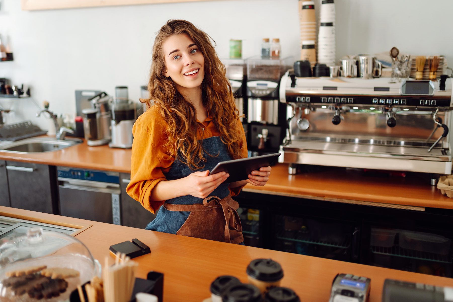Smiling Coffee Lady barista taking an order at the counter
