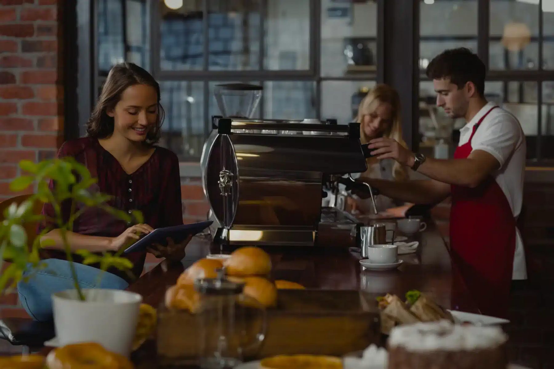 Baristas serving coffee in a busy café
