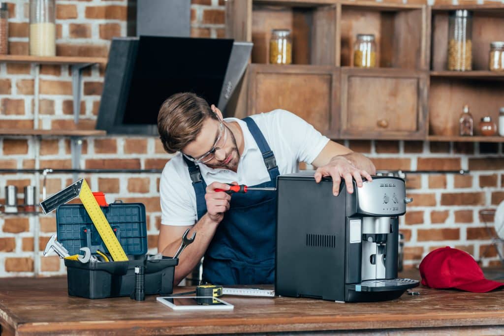 Qualified coffee machine technician servicing commercial equipment in the UK 2025