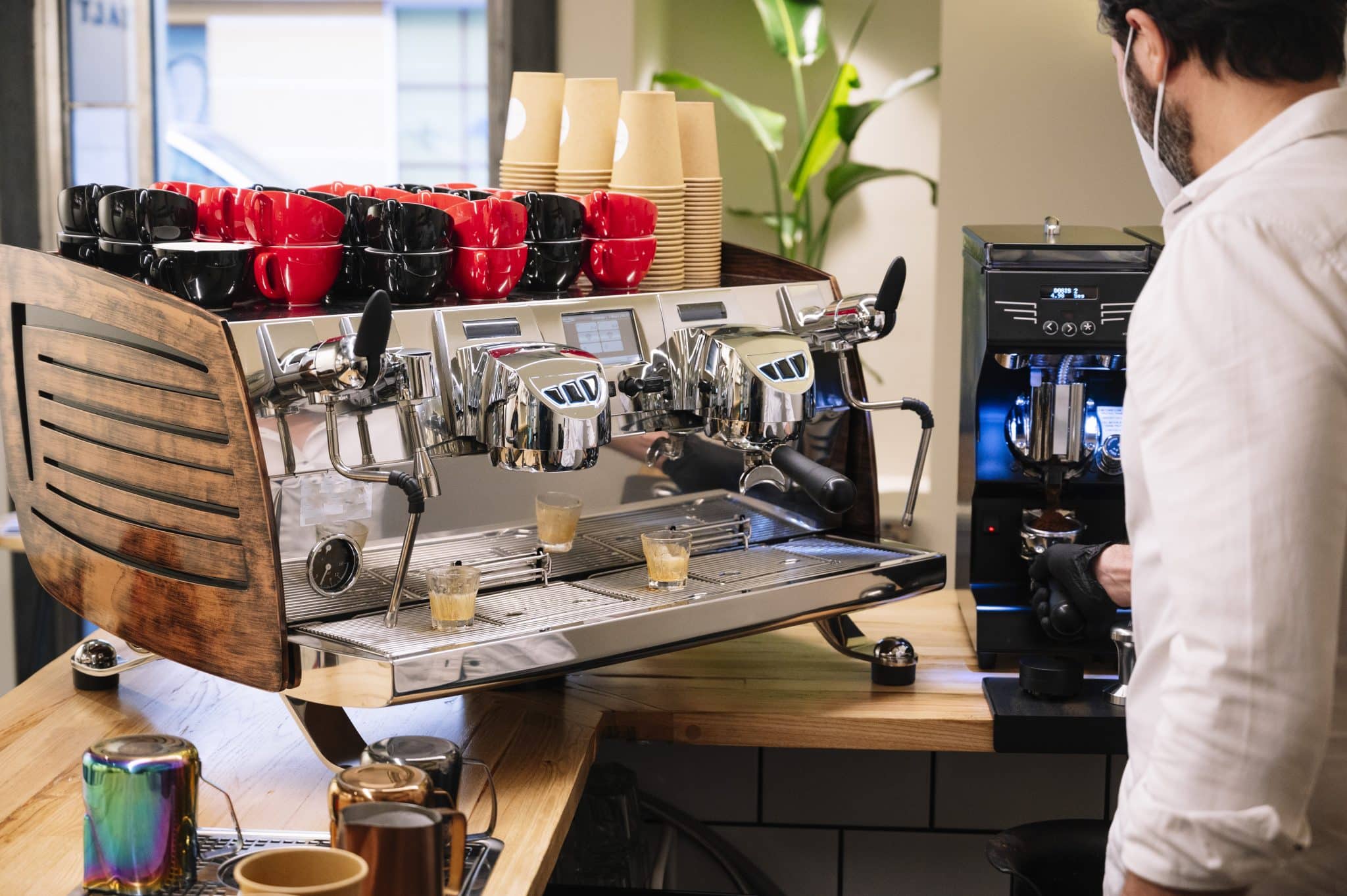 Barista using a Commercial Coffee Machines in a modern UK office 2025